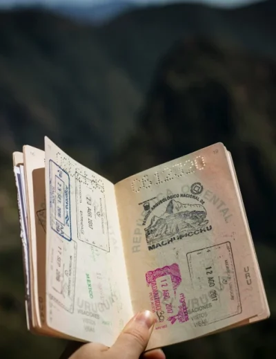 Open passport showing various visa stamps, highlighting global travel options with Lery Hago Travels