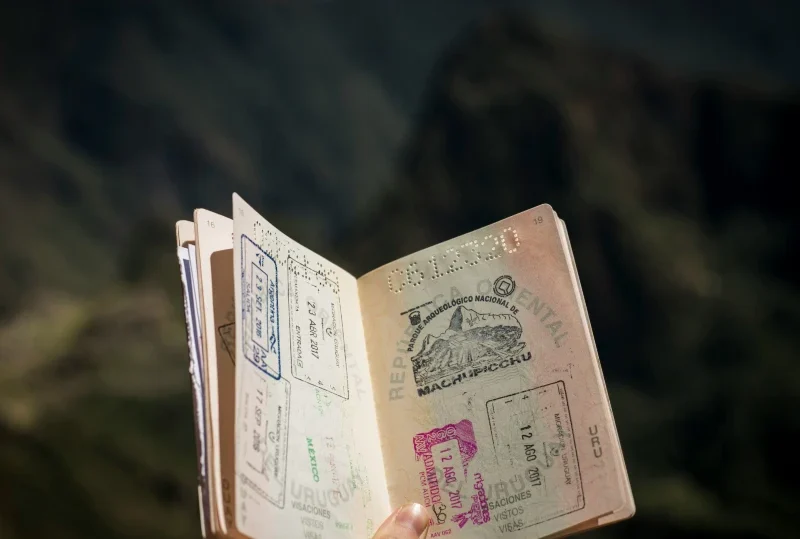 Open passport showing various visa stamps, highlighting global travel options with Lery Hago Travels