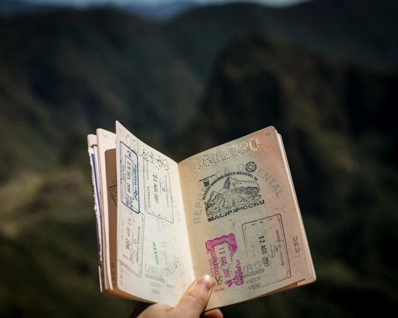 Open passport showing various visa stamps, highlighting global travel options with Lery Hago Travels