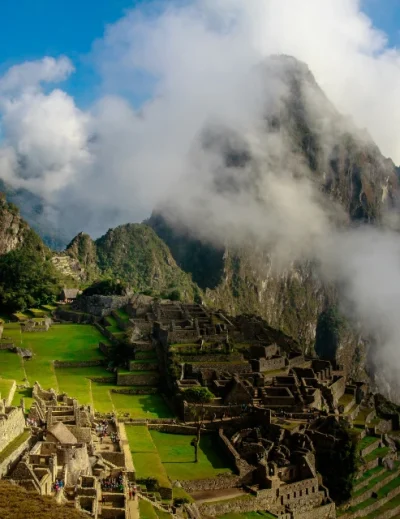 "A panoramic view of the ancient Incan city of Machu Picchu with mist-covered mountains in the background."