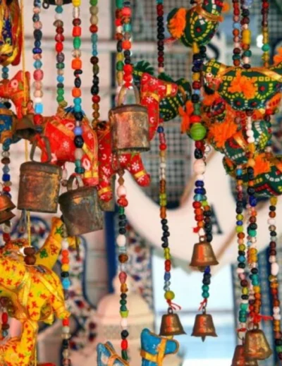 "Colorful handcrafted hanging souvenirs with beads, bells, and animal shapes, perfect gifts from Mauritius."