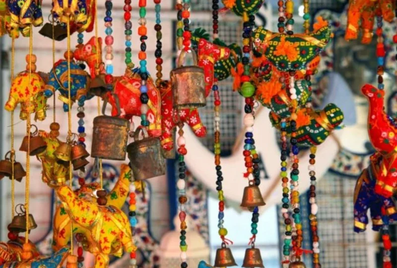 "Colorful handcrafted hanging souvenirs with beads, bells, and animal shapes, perfect gifts from Mauritius."