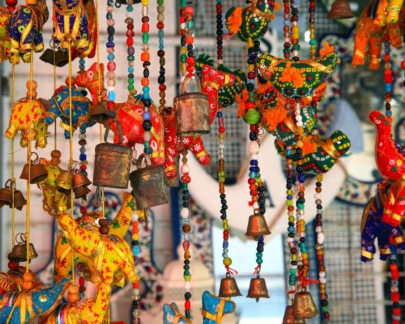 "Colorful handcrafted hanging souvenirs with beads, bells, and animal shapes, perfect gifts from Mauritius."