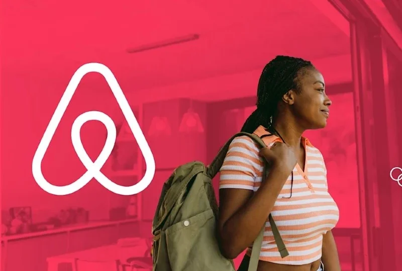 "A young woman with a backpack standing next to the Airbnb logo, symbolizing travel opportunities, including the 2025 travel grant to support elite athletes."