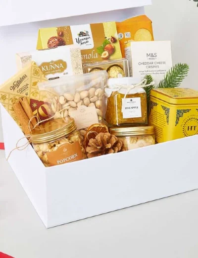 "A premium gift basket featuring popcorn, nuts, pineapple jam, tea, crackers, and gourmet treats, curated as a top souvenir idea by Lery Hago Travels."