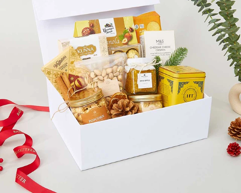 "A premium gift basket featuring popcorn, nuts, pineapple jam, tea, crackers, and gourmet treats, curated as a top souvenir idea by Lery Hago Travels."