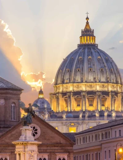 "A stunning view of St. Peter's Basilica in Vatican City illuminated at sunset, a key destination for the 2025 Catholic Jubilee in Rome."