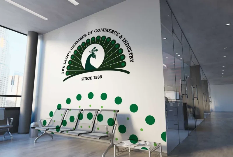 A modern office wall featuring the green peacock logo of the Lagos Chamber of Commerce & Industry (LCCI) with the inscription “Since 1888.”