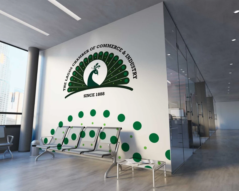 A modern office wall featuring the green peacock logo of the Lagos Chamber of Commerce & Industry (LCCI) with the inscription “Since 1888.”
