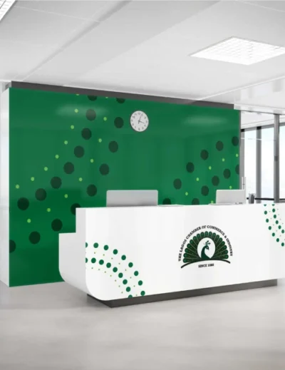 Reception area of the Lagos Chamber of Commerce and Industry (LCCI) featuring a green backdrop with circular patterns and a branded front desk.