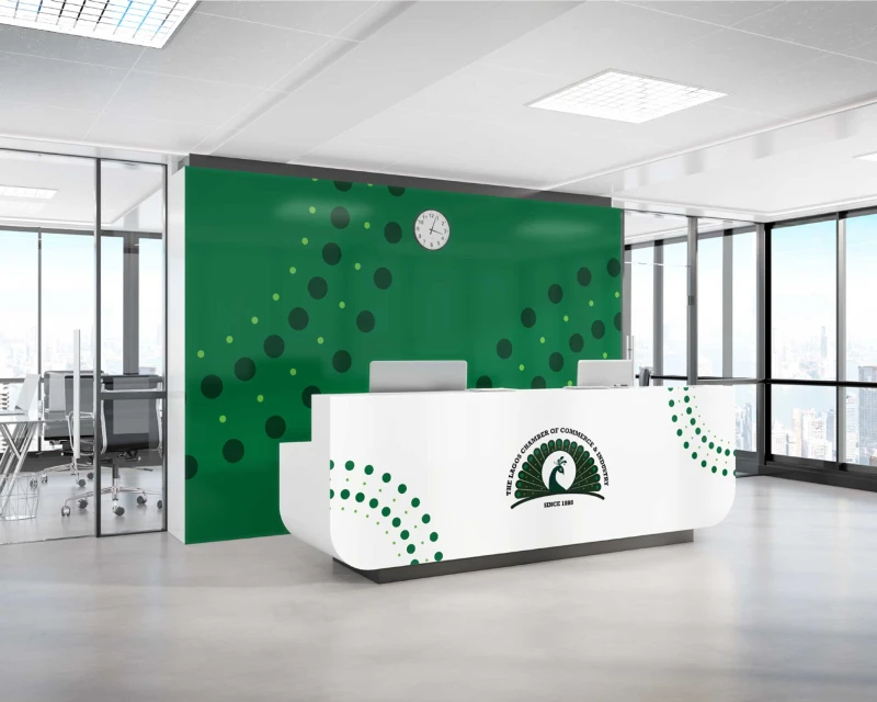 Reception area of the Lagos Chamber of Commerce and Industry (LCCI) featuring a green backdrop with circular patterns and a branded front desk.
