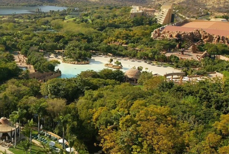 Aerial view of Sun City Resort surrounded by lush greenery, water features, and architectural landmarks in South Africa.