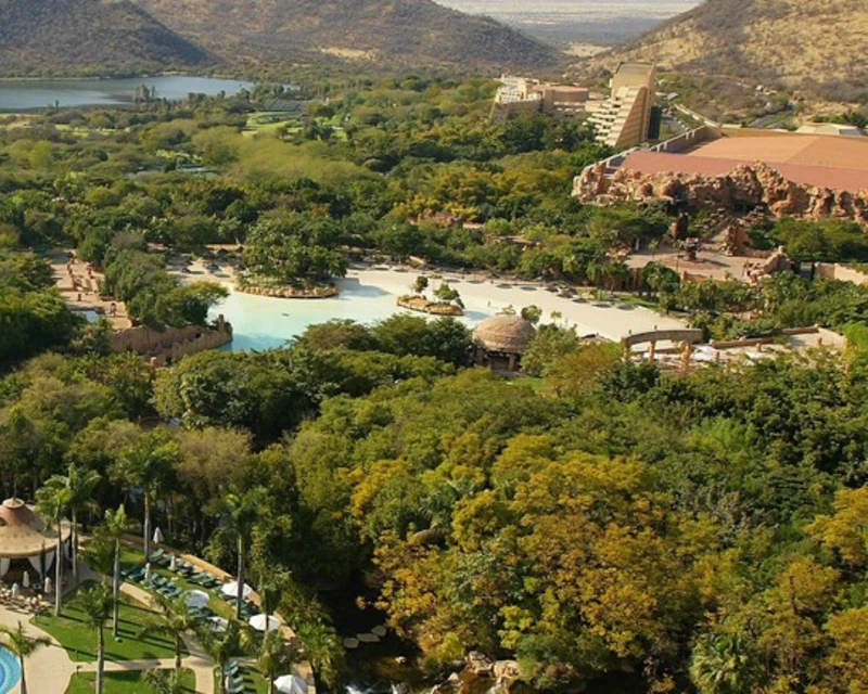Aerial view of Sun City Resort surrounded by lush greenery, water features, and architectural landmarks in South Africa.