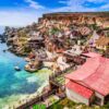 "Quaint colorful seaside village in Malta with traditional boats on azure waters, embodying a historical getaway, image courtesy of www.leryhago.com."