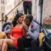 "A couple in a loving embrace on a Venetian gondola captures the essence of a Venice Valentine's Getaway - find romance tips at www.leryhago.com."