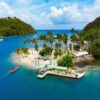 "Luxurious Christmas St. Lucia Package - Aerial view of a serene St. Lucia beach with palm trees and boats, highlighting exclusive holiday deals at www.leryhago.com"