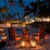 "Intimate beachfront dinner setup at night with lanterns on a Zanzibar Summer Holiday, inviting romance at www.leryhago.com."
