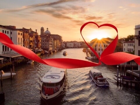 "A ribbon heart framing a sunset over the Venice Grand Canal, capturing the romantic essence of a Venice Valentine's Getaway - start your journey at www.leryhago.com."
