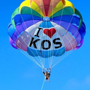 "Colorful hot air balloon with 'I Love Kos' text soaring in the bright blue sky, capturing the adventurous spirit of Pre-Christmas Magic in Mauritius."