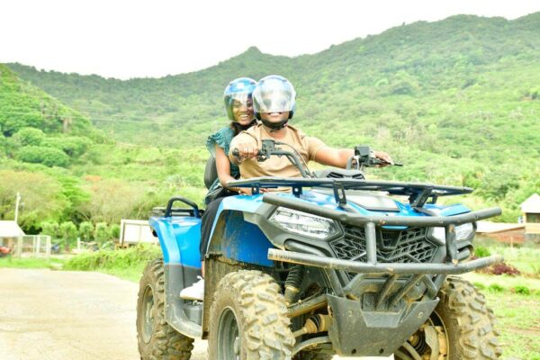 "Couple on an ATV adventure amidst the lush greenery of Mauritius, enjoying the island's pre-Christmas magic."