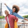 "Joyful Black couple enjoying a Paris Love Getaway with the Eiffel Tower in the background, discover more at www.leryhago.com."