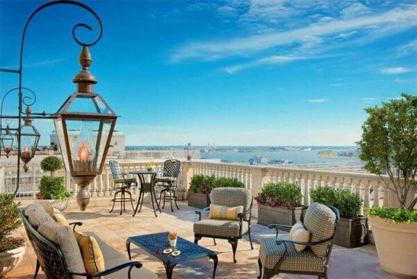 "An elegant terrace with cozy seating overlooking the harbor, a prime spot for a Romantic Getaway in New Orleans - plan your stay at www.leryhago.com."
