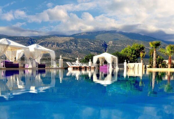 "Elegant cabanas by an infinity pool with mountain views on a Romantic Turkey Tour, offered by www.leryhago.com."