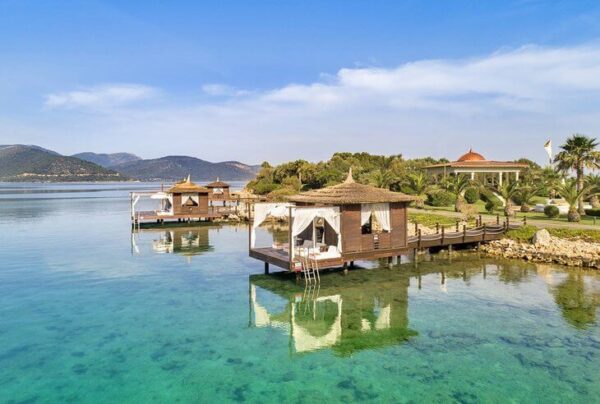 "Overwater bungalows with thatched roofs in Turkey, offering a secluded retreat on www.leryhago.com's Romantic Turkey Tour."