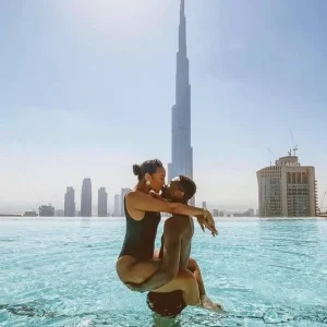 Black couple enjoying the beach with a view of the Burj Khalifa in Dubai