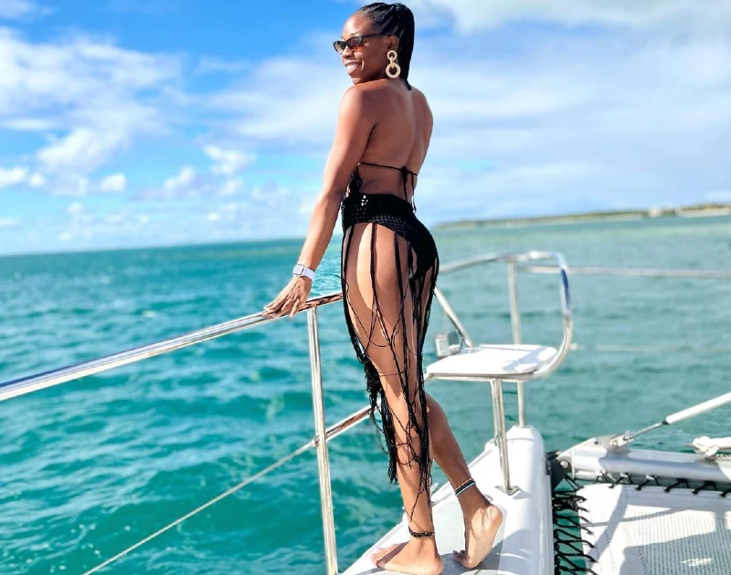 A woman enjoying the ocean view on a yacht during her solo travel experience with Lery Hago Travels.