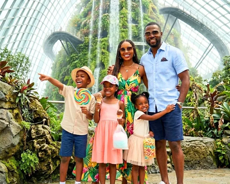 An african family taking a picture in the cloud garden in Singapore