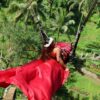 an african woman on the Bali swing in Bali, indonesia