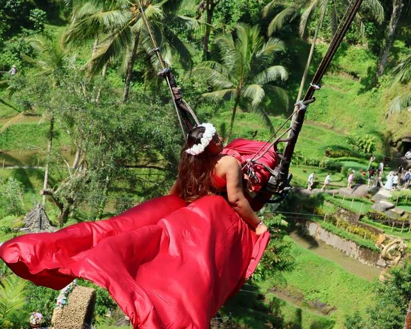 an african woman on the Bali swing in Bali, indonesia