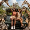 two african ladies sitting on a safari vehicle in Thailand