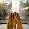 a group of african ladies in their early 20s taking a group selfie in front of the the cloud garden in SIngapore